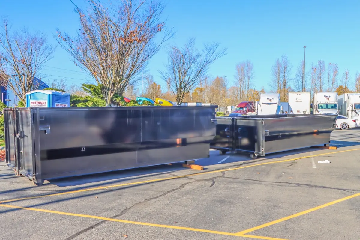 Professional dumpster rental service with roll-off container on residential driveway in Havre de Grace